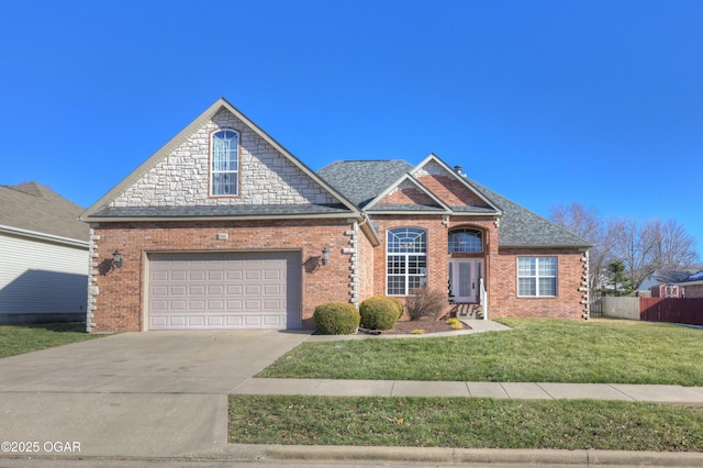 view of front of property featuring a front yard and a garage