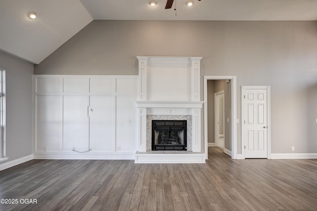 unfurnished living room with ceiling fan, hardwood / wood-style flooring, and high vaulted ceiling