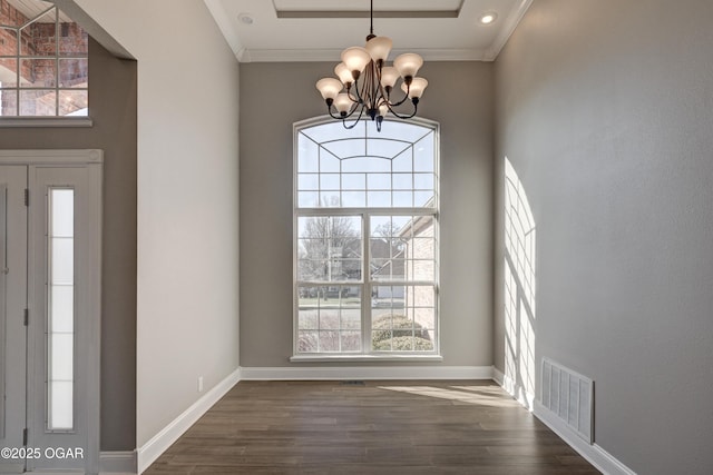 entryway featuring a chandelier, crown molding, and dark hardwood / wood-style flooring