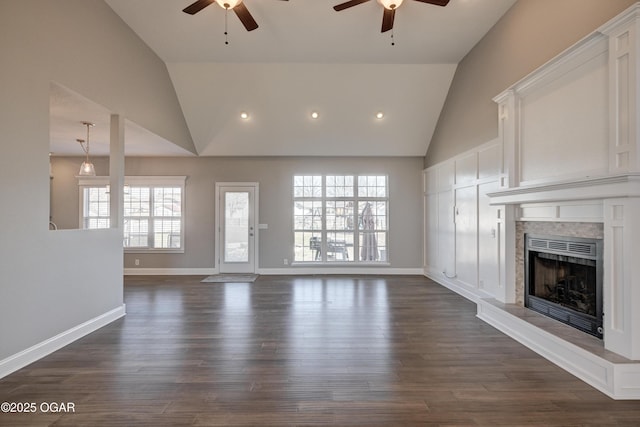 unfurnished living room featuring ceiling fan, dark hardwood / wood-style floors, and high vaulted ceiling