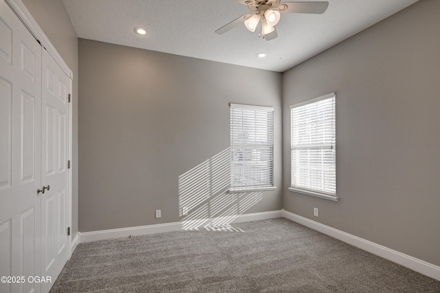 spare room with carpet floors, a textured ceiling, and ceiling fan