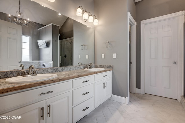 bathroom with walk in shower, vanity, and a notable chandelier