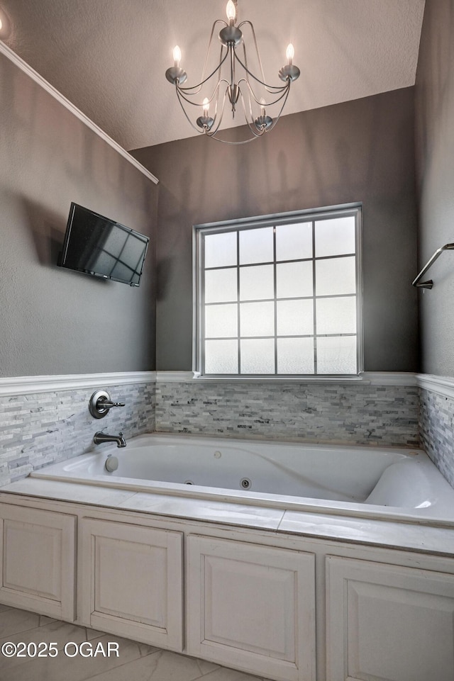 bathroom with vaulted ceiling, a washtub, and a chandelier