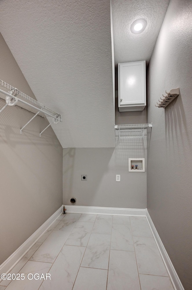 washroom featuring a textured ceiling, hookup for an electric dryer, hookup for a washing machine, and hookup for a gas dryer