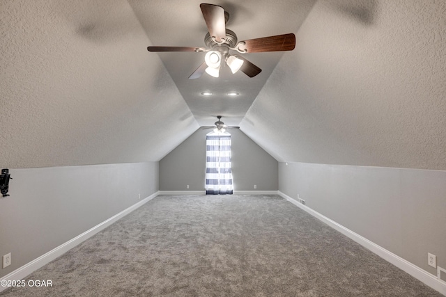 bonus room featuring carpet, ceiling fan, a textured ceiling, and lofted ceiling