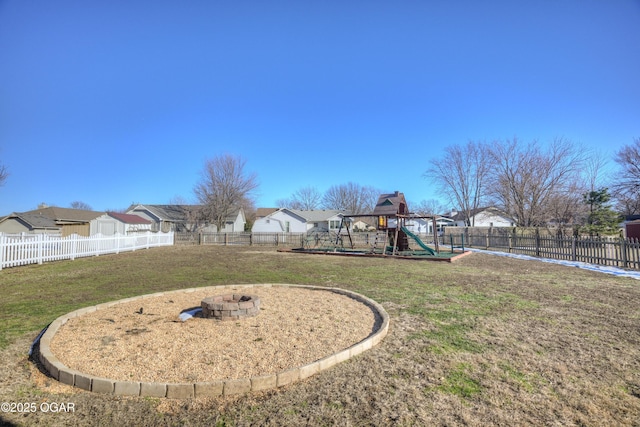 view of yard with a playground and an outdoor fire pit