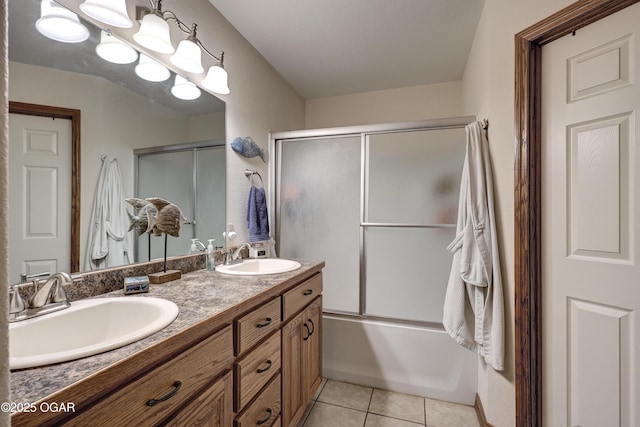 bathroom featuring enclosed tub / shower combo, tile patterned flooring, and vanity