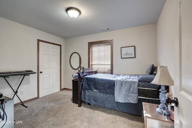 bedroom featuring a textured ceiling and light carpet