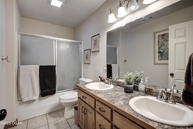 full bathroom with vanity, toilet, tile patterned flooring, and bath / shower combo with glass door