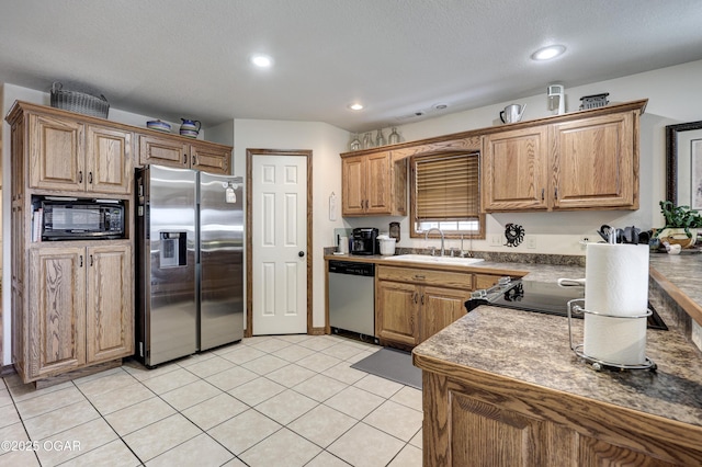 kitchen with stainless steel appliances, sink, and light tile patterned floors