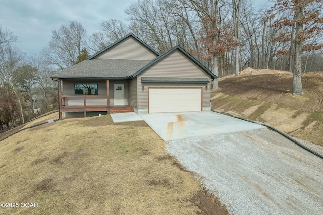 single story home featuring a porch, a garage, and a front lawn