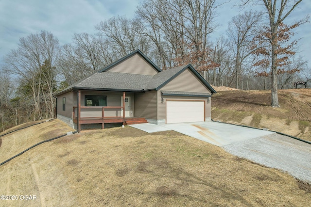 view of front of home featuring a porch, a garage, and a front yard