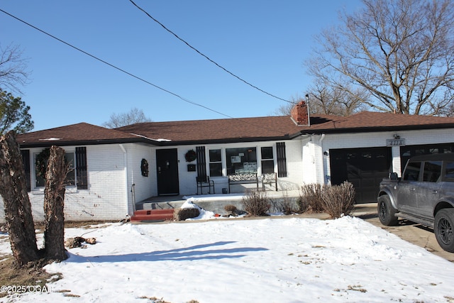 ranch-style house with a garage and a porch