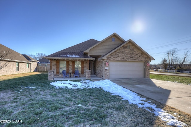 view of front of home featuring covered porch, a yard, and a garage