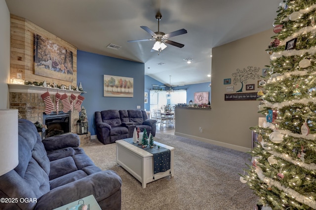 living room featuring vaulted ceiling, ceiling fan, light colored carpet, and a brick fireplace