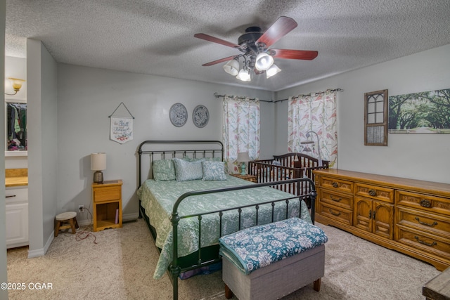 carpeted bedroom with ceiling fan and a textured ceiling