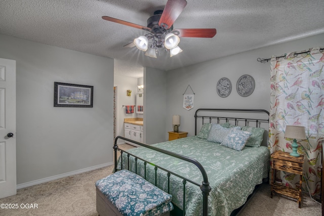 carpeted bedroom with a textured ceiling, ceiling fan, and connected bathroom