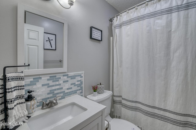 bathroom featuring toilet, tasteful backsplash, walk in shower, a textured ceiling, and vanity