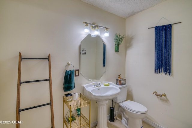 bathroom with a textured ceiling and toilet