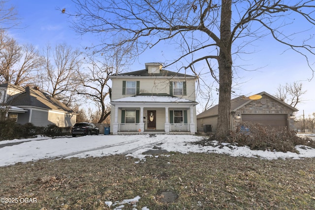 view of front facade with covered porch and a garage