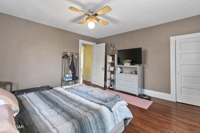 bedroom with ceiling fan and dark hardwood / wood-style floors