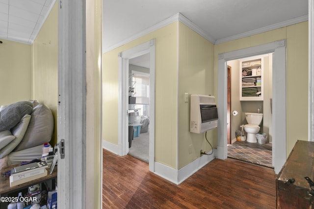 corridor with dark hardwood / wood-style floors, heating unit, and crown molding