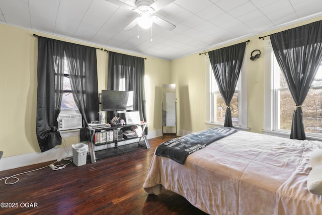 bedroom featuring ceiling fan, ornamental molding, cooling unit, and dark hardwood / wood-style floors