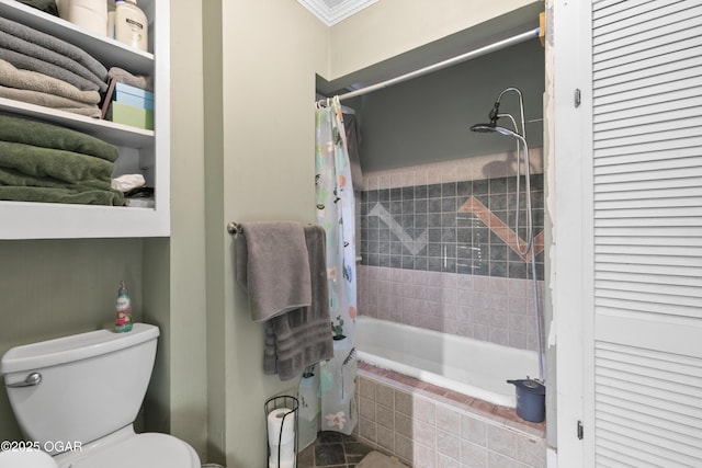 bathroom featuring toilet and shower / bath combination with curtain