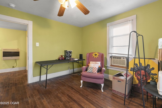 sitting room with ceiling fan, heating unit, cooling unit, and dark hardwood / wood-style floors