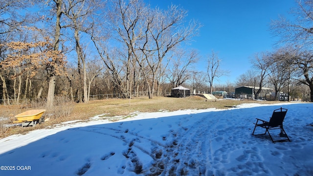 yard layered in snow with a gazebo