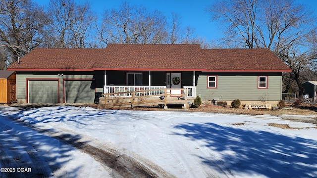 single story home with a garage and a porch