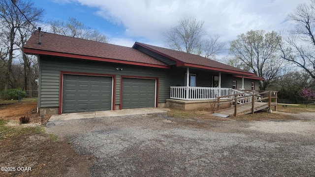 6539 SE Quaker Rd, Galena, KS 66739 - view of front of home with covered porch, an attached garage, roof with shingles, and asphalt driveway