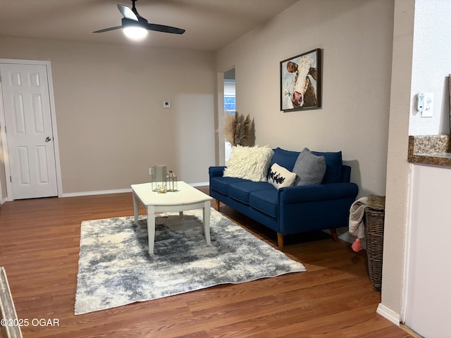 living room featuring wood-type flooring and ceiling fan