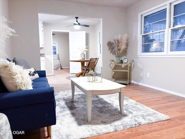 living room featuring ceiling fan and light wood-type flooring