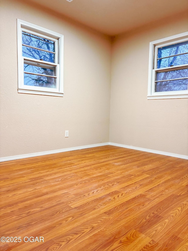 empty room with light hardwood / wood-style floors