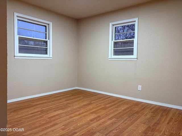 spare room with light hardwood / wood-style floors