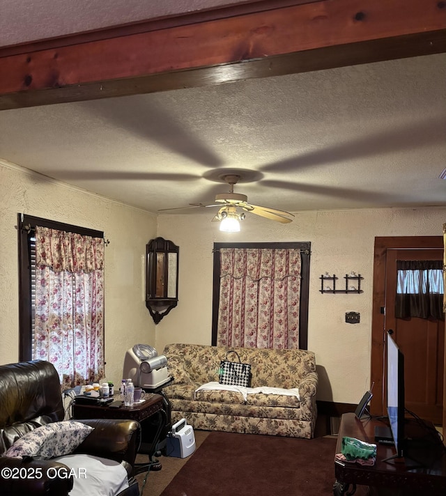 living room with a textured ceiling and ceiling fan