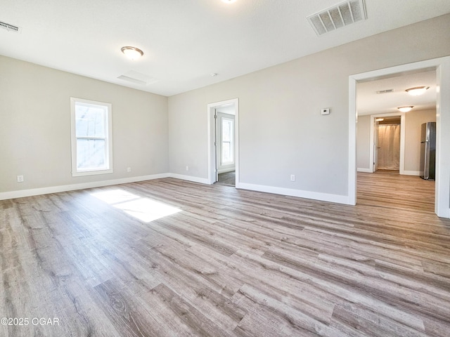 spare room featuring light hardwood / wood-style flooring