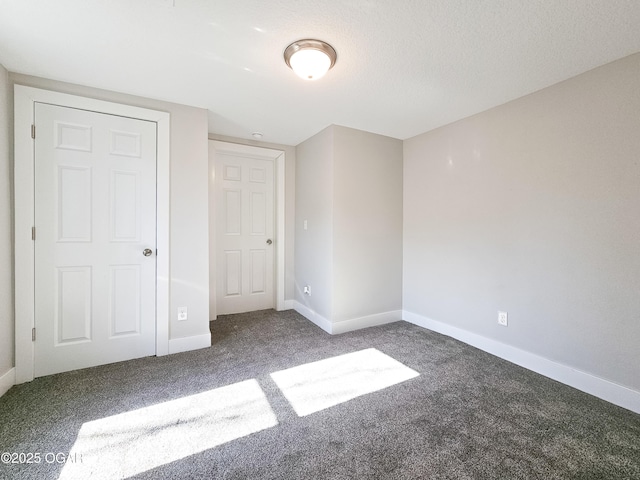 unfurnished bedroom featuring a closet and dark colored carpet