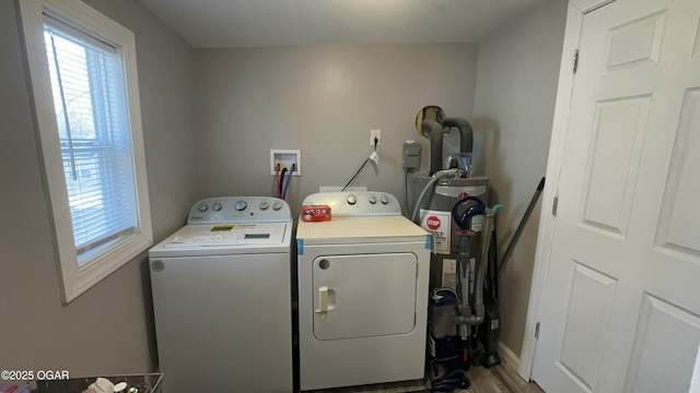 washroom with water heater and washing machine and clothes dryer