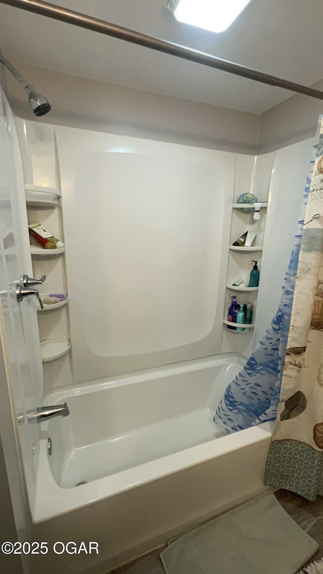 bathroom with shower / tub combo and wood-type flooring