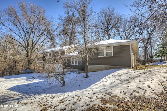 snow covered property featuring central air condition unit