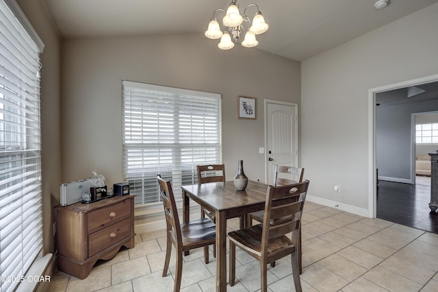 tiled dining area with vaulted ceiling and a notable chandelier