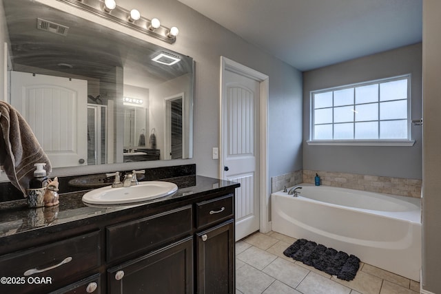 bathroom featuring plus walk in shower, tile patterned flooring, and vanity