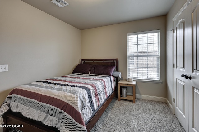 bedroom featuring light colored carpet