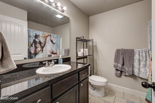 bathroom with tile patterned floors, vanity, and toilet