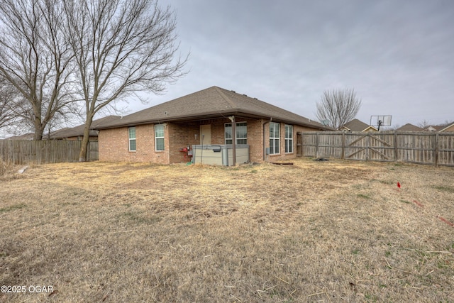 rear view of property with a lawn