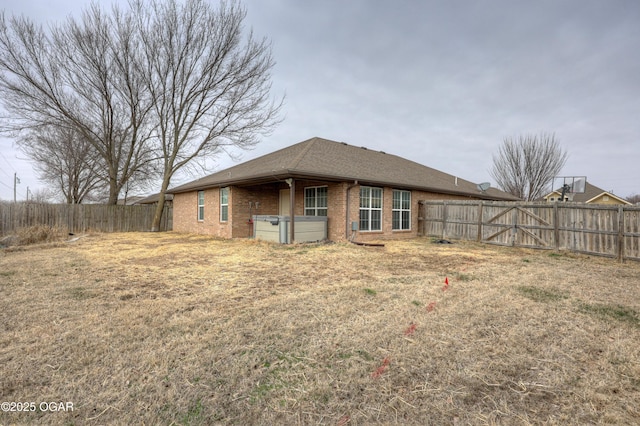 back of house featuring a yard