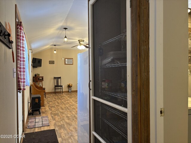 kitchen featuring hardwood / wood-style flooring, ceiling fan, and lofted ceiling