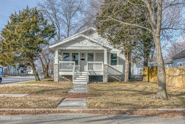 bungalow-style house with covered porch and a front yard